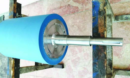Industrial roller being ground after polyurethane coating
